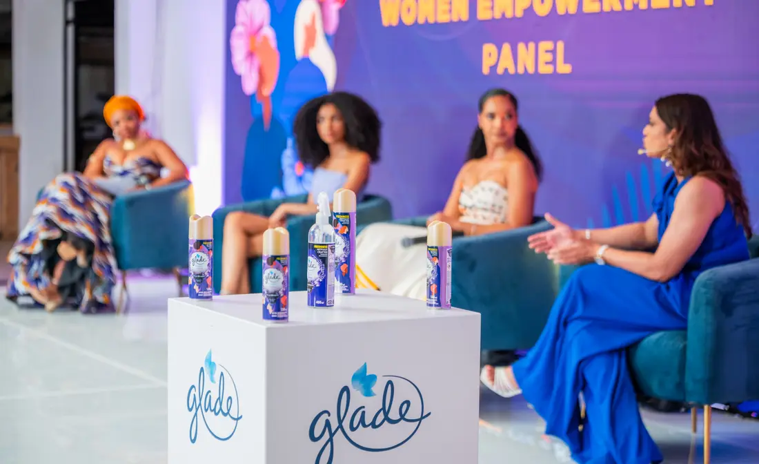 A Women Empowerment Panel on stage, with Glade products on a plinth in front of it